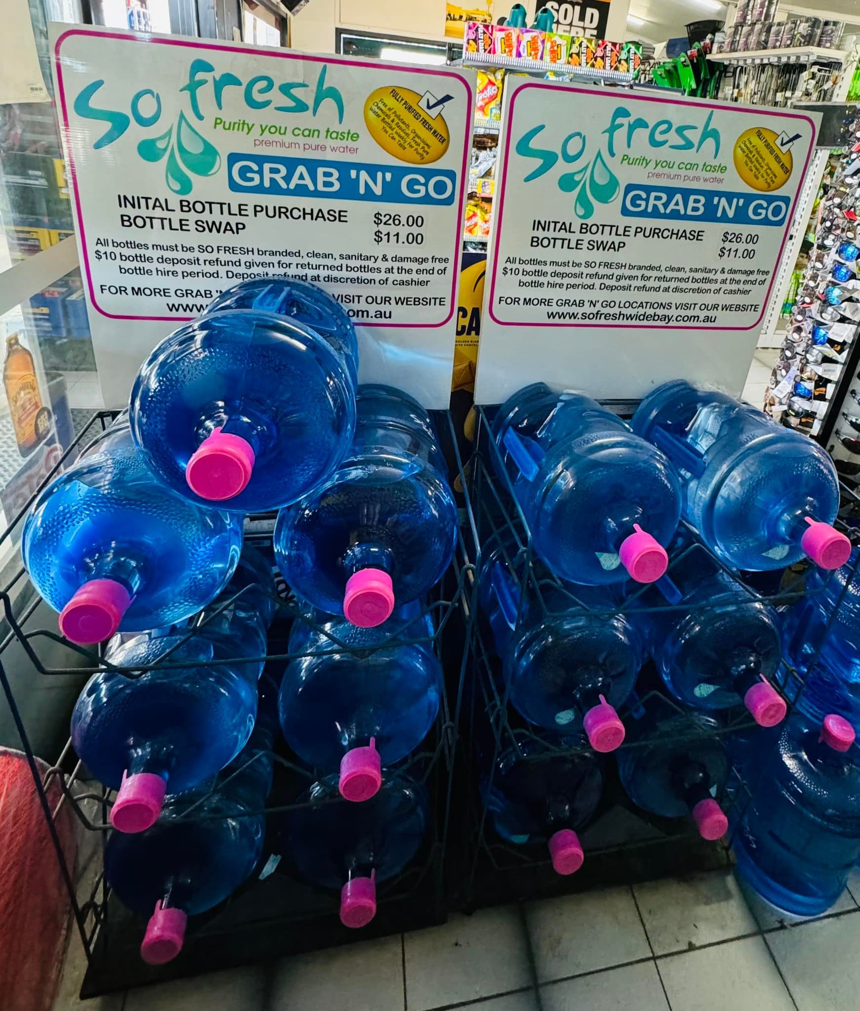 Stacked Blue Water Jugs at a Store Display With “so Fresh Grab N Go” Signs — So Fresh Wide Bay in Innes Park, QLD