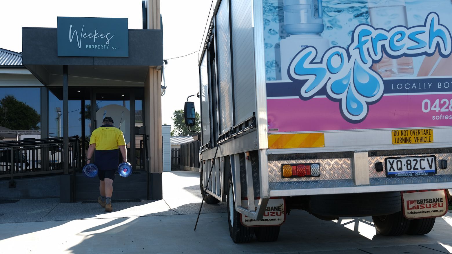 Truck With Ad Parked by a Storefront and Person Walks Toward the Entrance — So Fresh Wide Bay in Thabeban, QLD