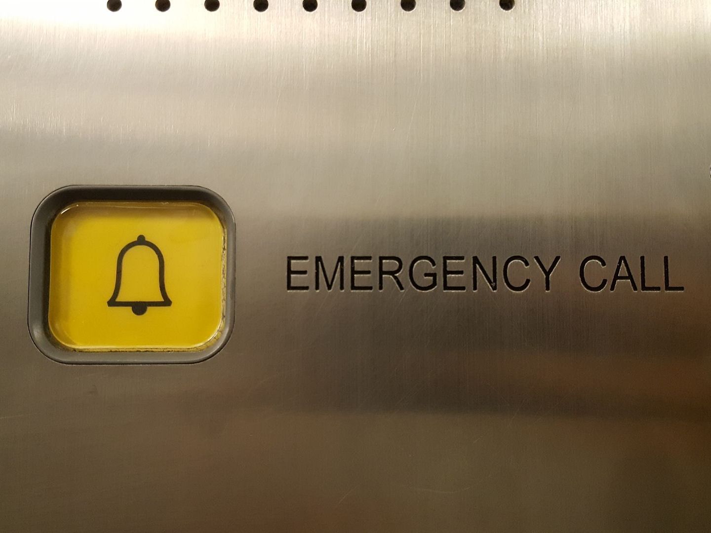 An emergency call button with a bell on it