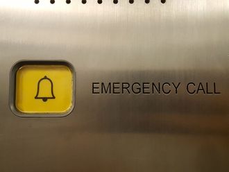 An emergency call button with a bell on it