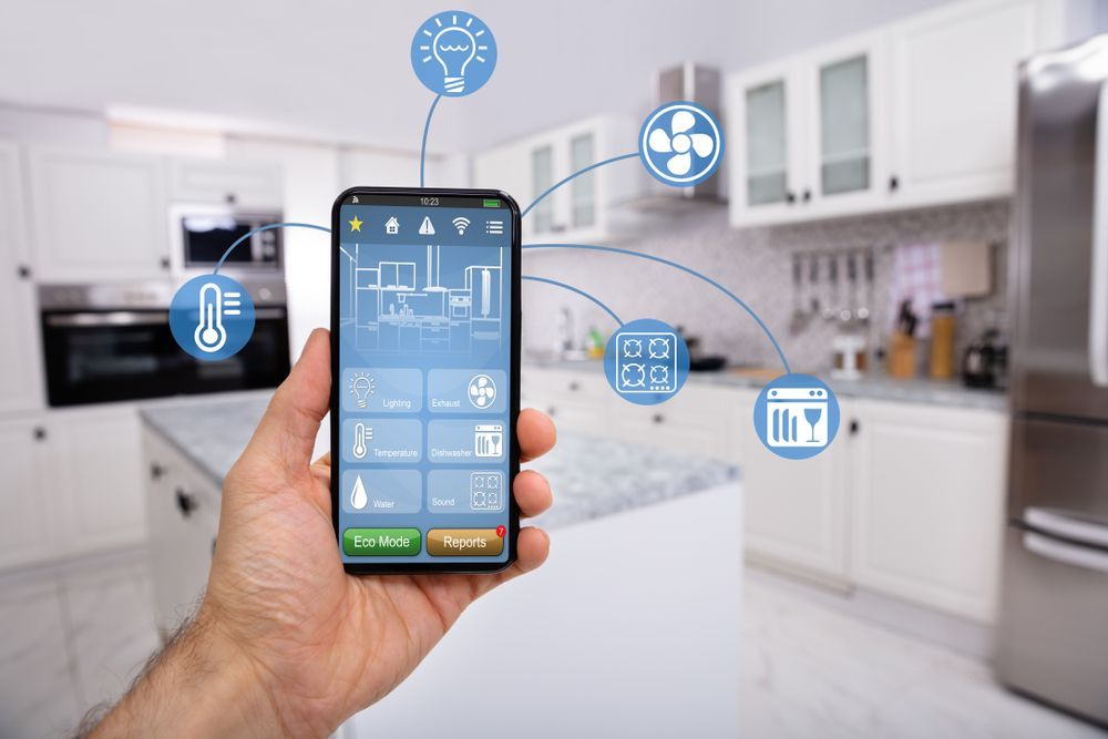 A Person is Holding a Smart Phone in Their Hand in a Kitchen — Advantage Communications & Electrical in Caloundra, QLD