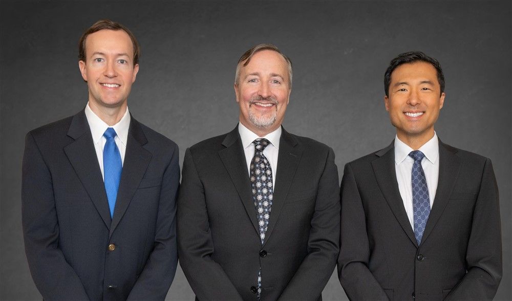 A group of people in suits and ties are posing for a picture.