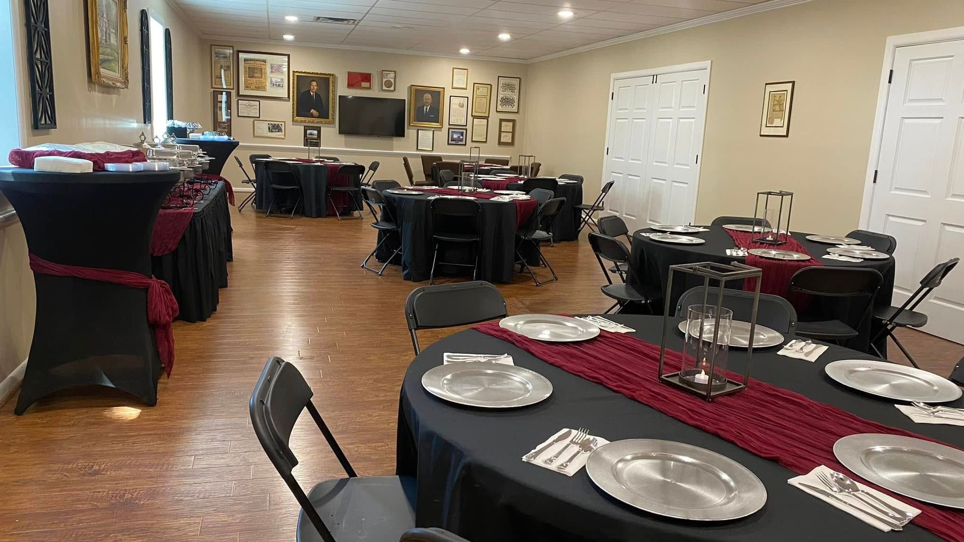 A large room with tables and chairs set up for a party.
