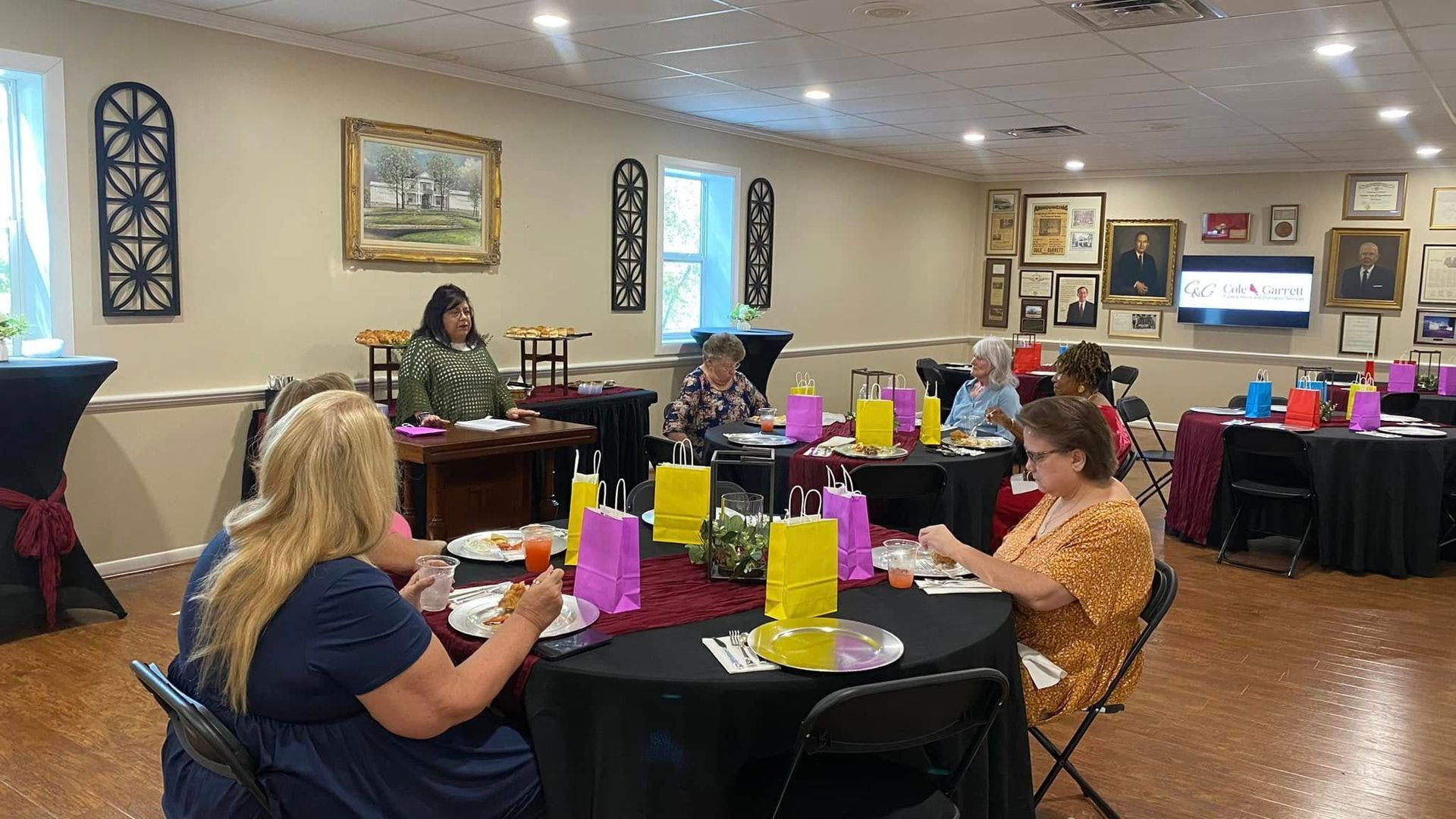 A group of people are sitting at tables in a room.