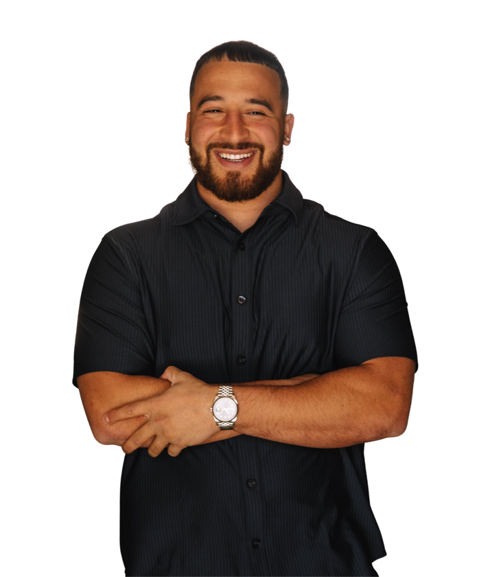 Man smiling, arms crossed, wearing a black button-up shirt and watch.