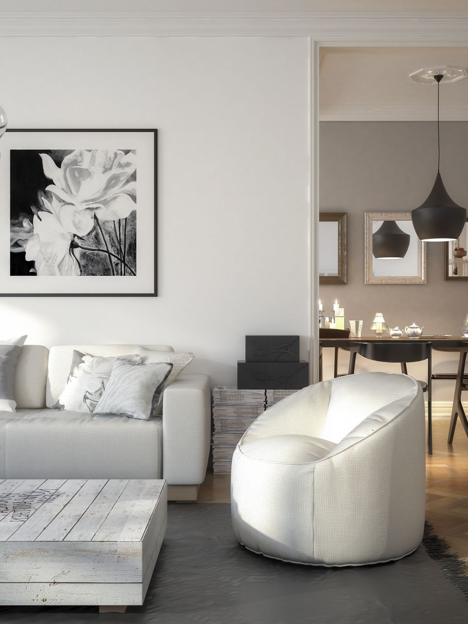 Living room with a white couch, a black and white floral print, and a modern white chair.