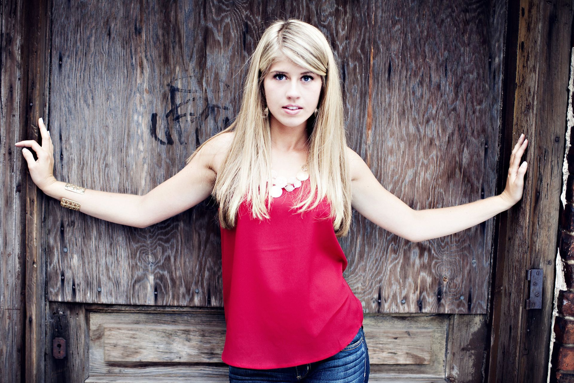 High school senior girl posing against a downtown Grand Rapids, MI industrial door.