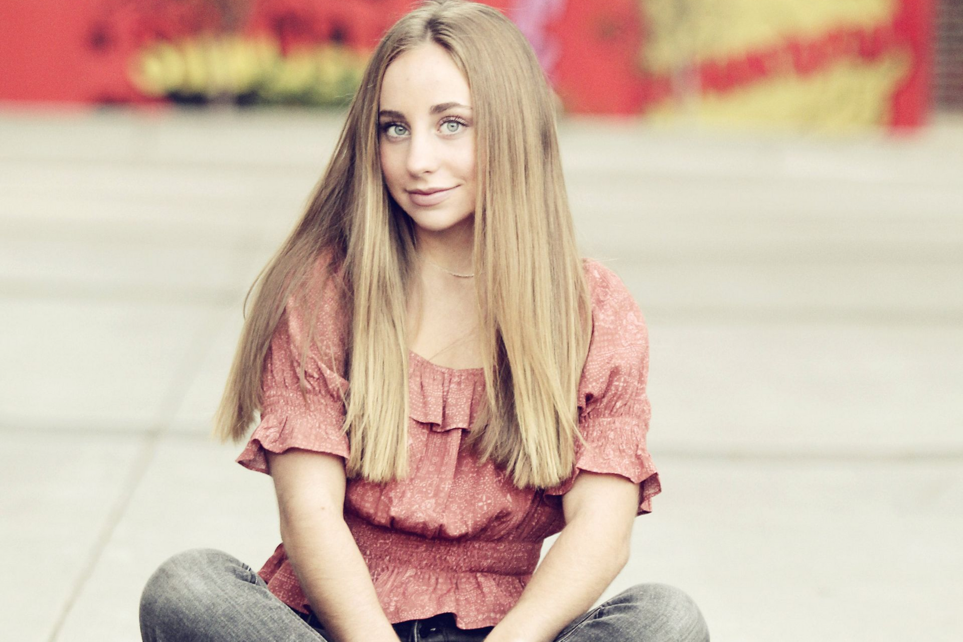 High school senior girl in downtown grand rapids, michigan with art scene in background.