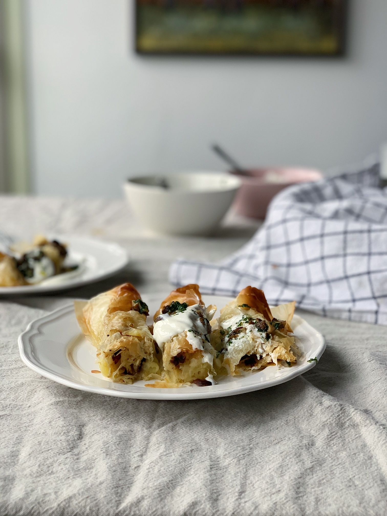 Plate of untraditional burek made with leftovers stampot and mushrooms, sour cream