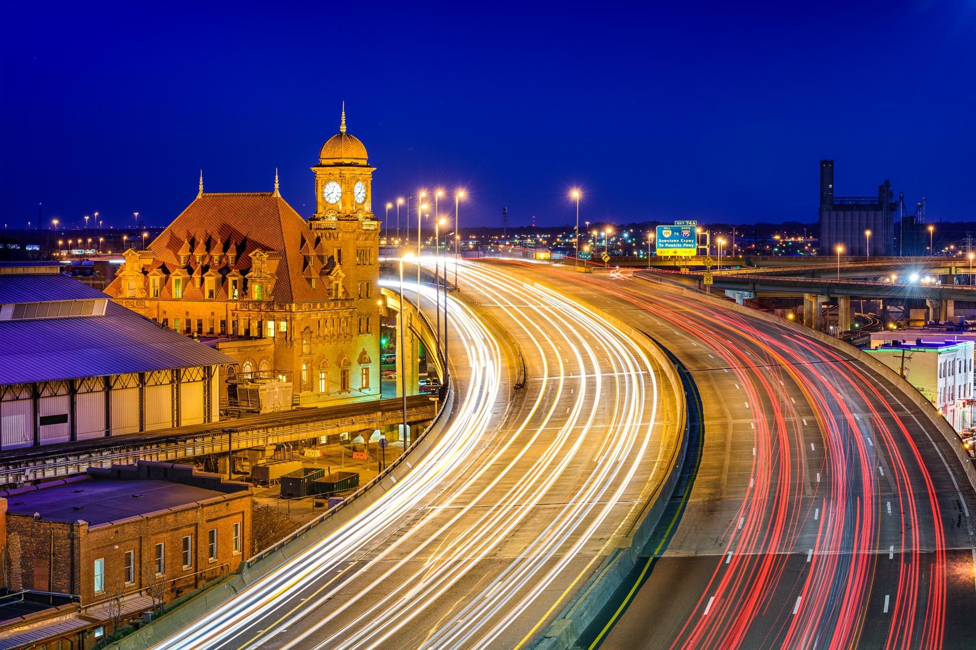 a highway with a clock tower in the background