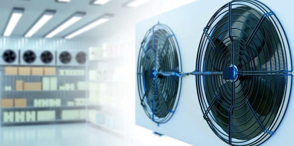 Two Fans Are Sitting Next to Each Other in a Room —​ Centre Evap & Home Maintenance Services in Ciccone, NT