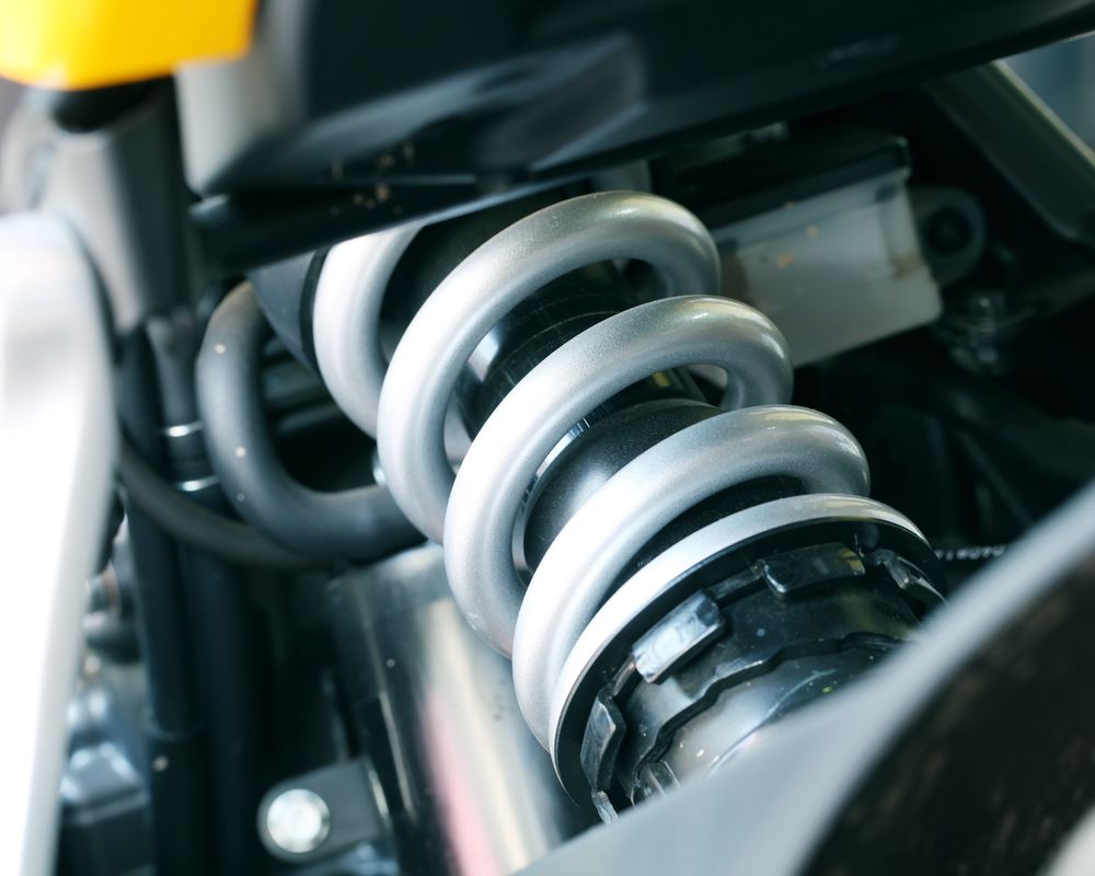 Close-up of a Motorcycle's Silver Coil Spring Shock Absorber — GA Plant & Automotive Repairs In Inverell, NSW
