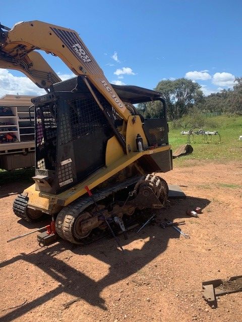 Yellow and Black Tracked Skid Steer With an Extended Arm — GA Plant & Automotive Repairs In Taminda, NSW