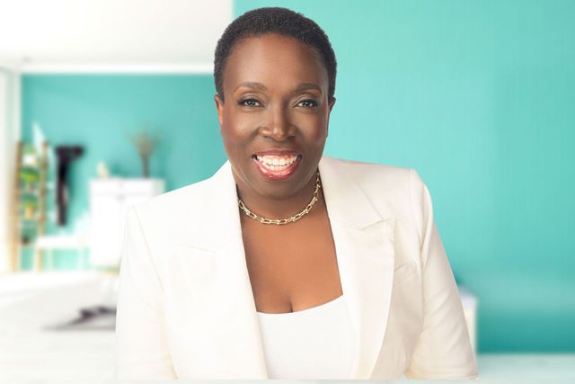 photo of Dr. Judi smiling in a cream color suit
