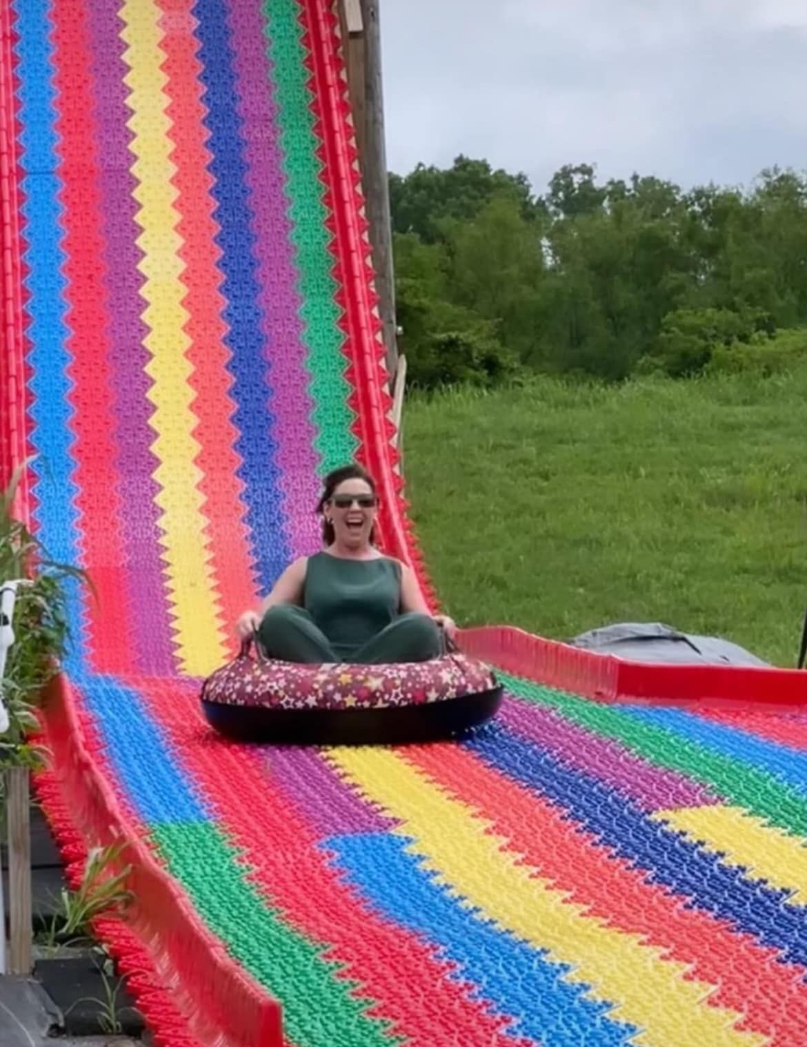 A woman is riding a mega tube slide at river city adventure park