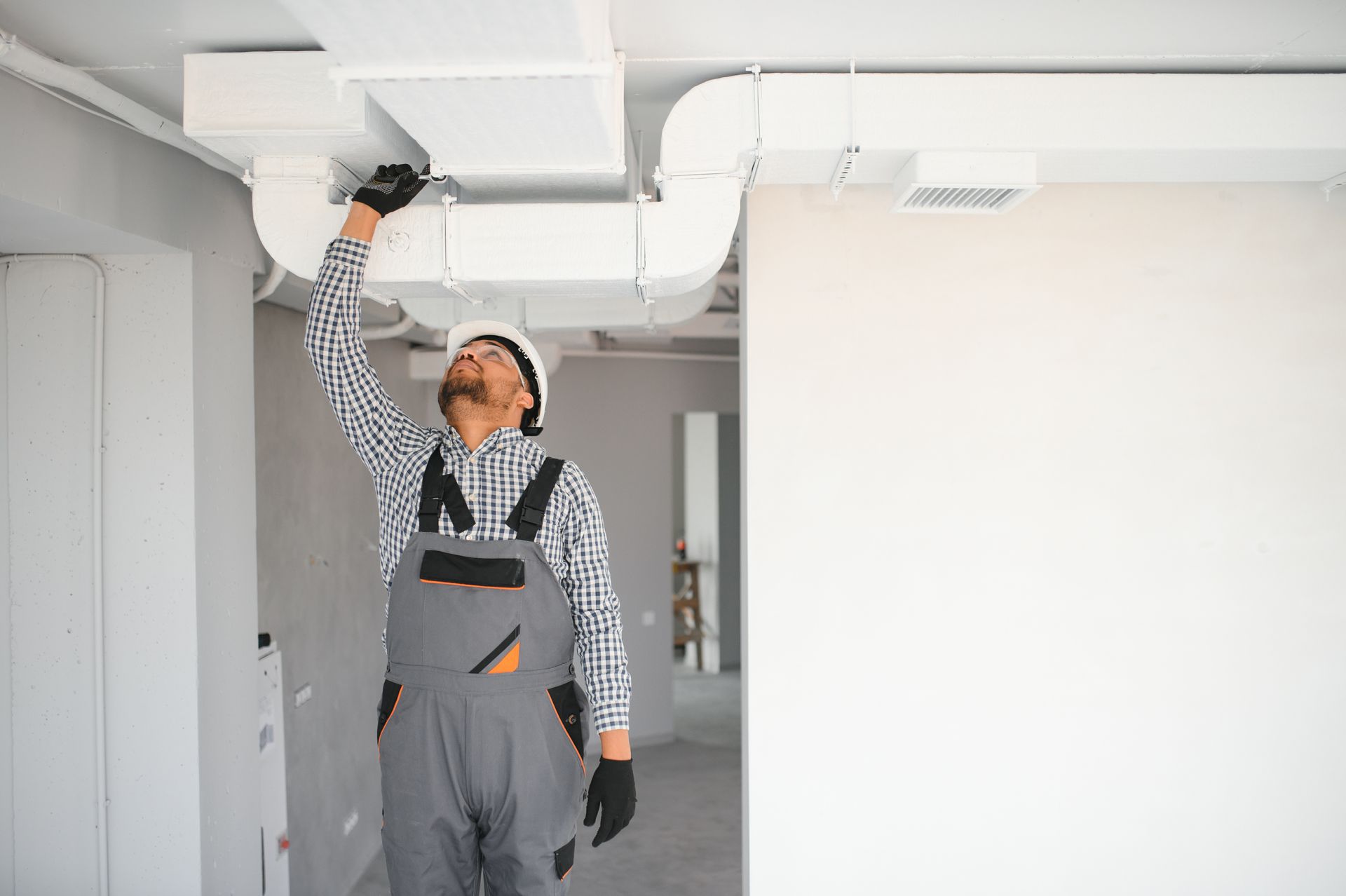 The technician cleans ducts, removing debris to boost air quality and system efficiency. The technician cleans ducts, removing debris to boost air quality and system efficiency.