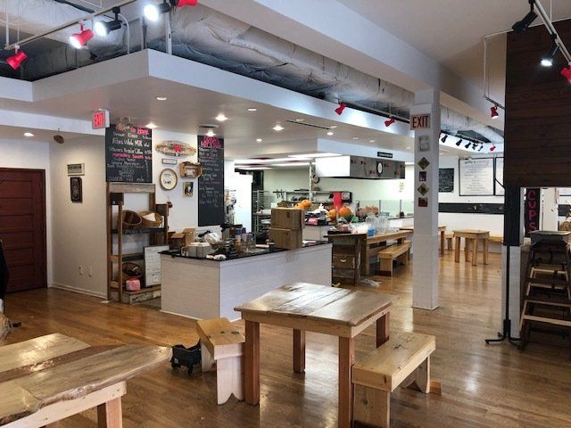 2901 Central restaurant space with counter, ceiling fan, and tables and benches for example purposes.