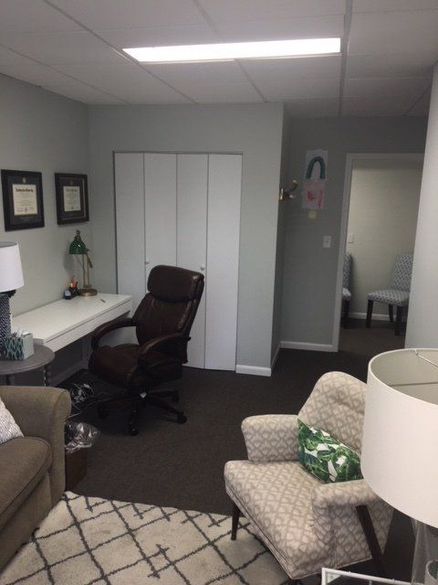 Office suite with desk, three chairs, and rug for example purposes.