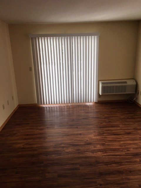 Living room with patio sliding door and blinds