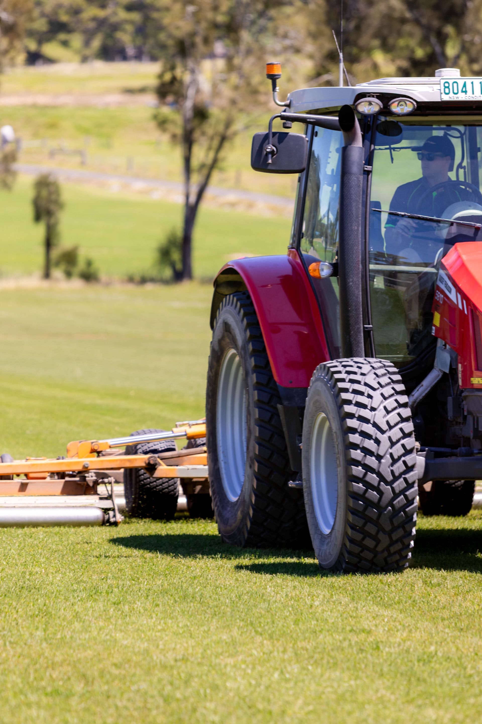 Red tractor on Kenda Kikuyu Grass