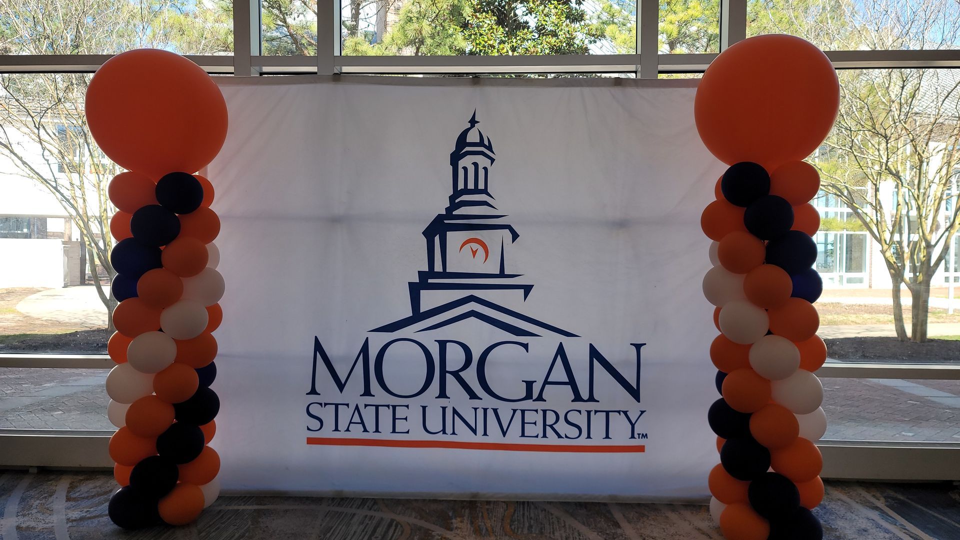 a banner for morgan state university is surrounded by balloons