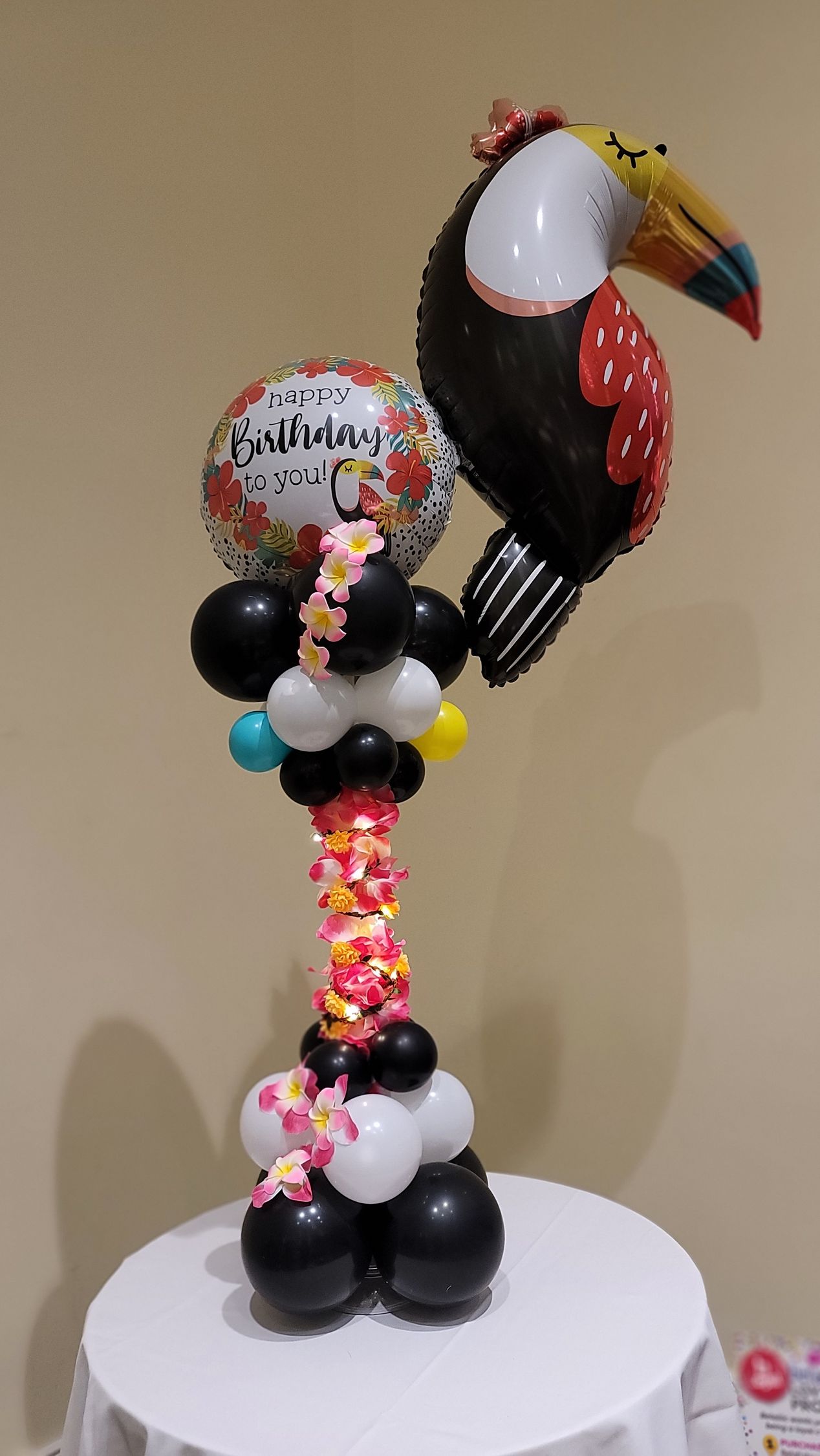 a bird made out of balloons is sitting on top of a table .
