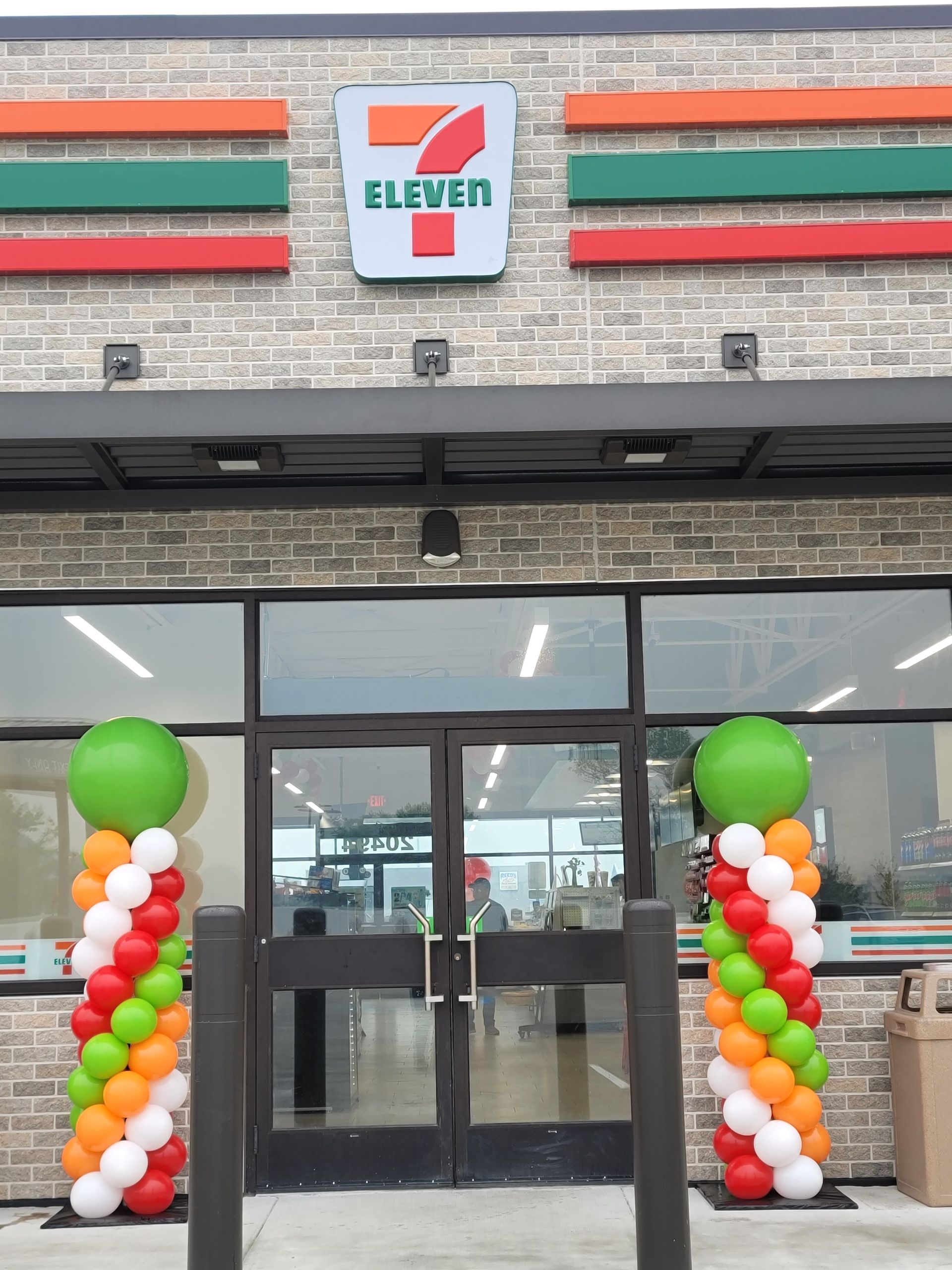 a 7 eleven store with balloons in front of it