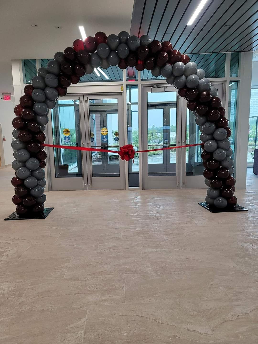 a large arch made of balloons in front of a door