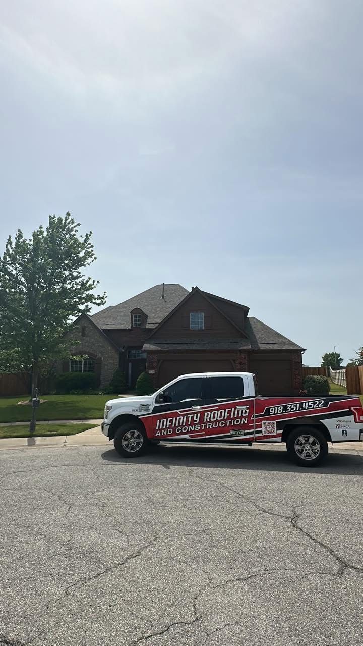 Red-and-white advertising truck parked in front of a suburban house on a sunny day