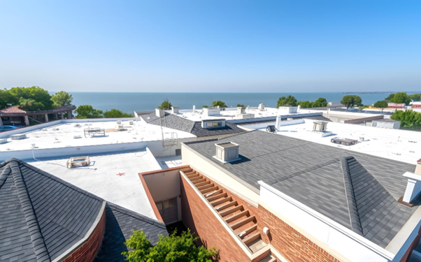 White coastal rooftops with blue ocean and sky in the distance