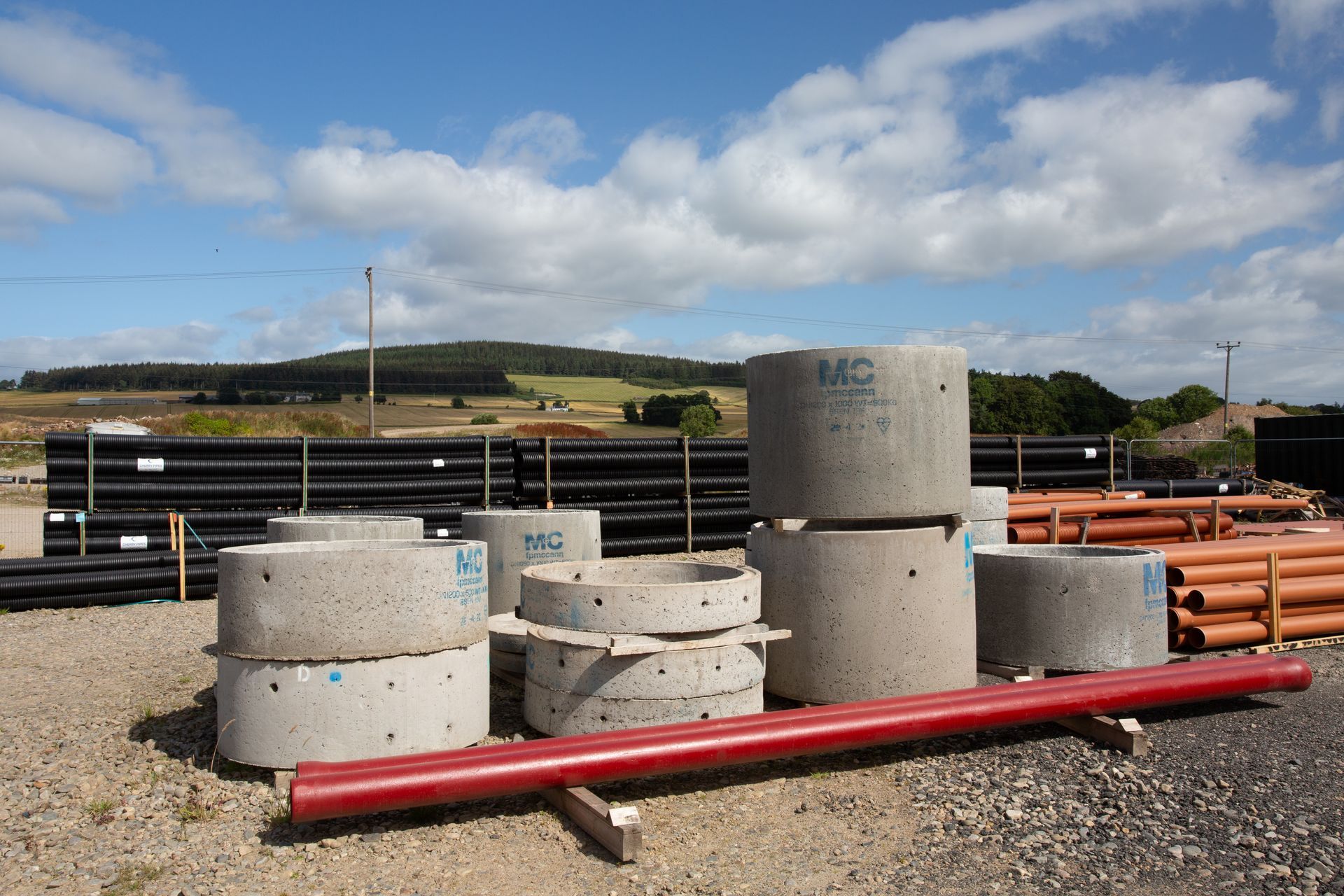 A bunch of concrete pipes are stacked on top of each other