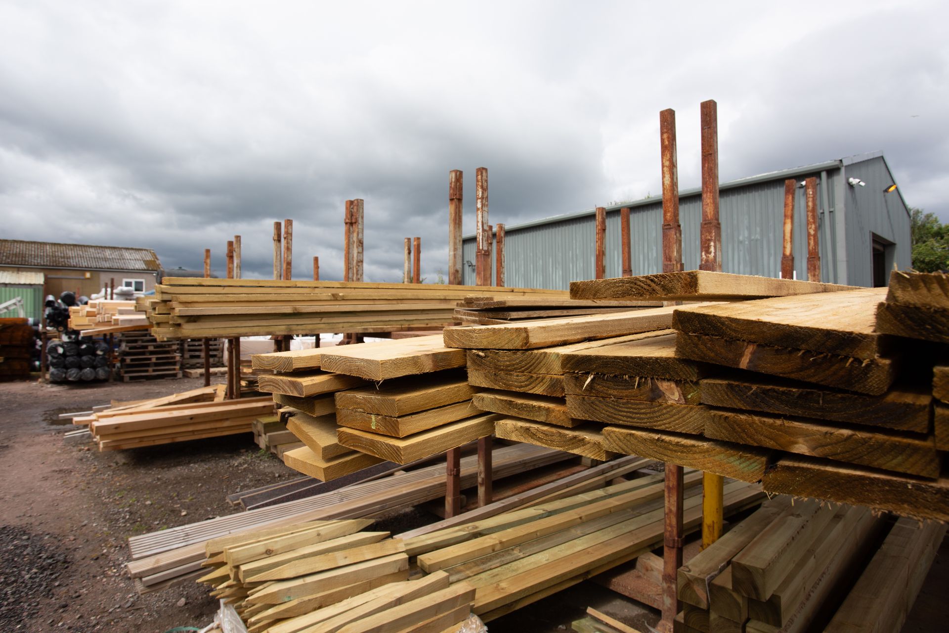 A pile of wood is sitting in front of a building.