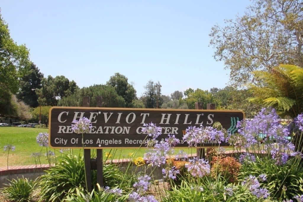 Cheviot Hills sign with trees and purple flowers, buy a home in Beverly Hills with top realtors in Santa Monica, Lisa Kirshner Properties