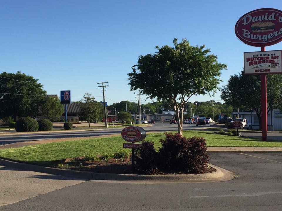 Commercial Lawn Maintenance by Southerngrounds shows a sign for David 's burger is on the side of the road.