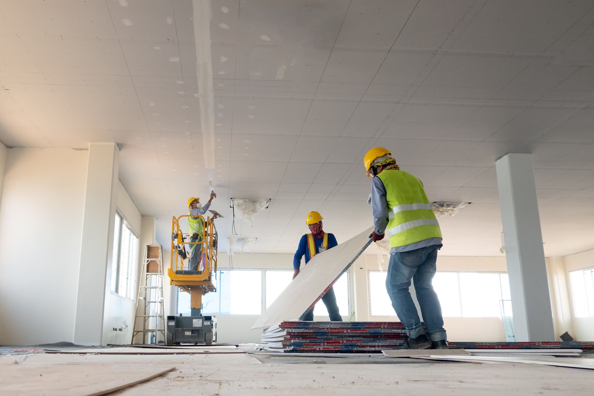 A group of construction workers are working on a building.