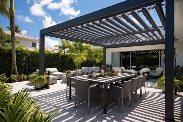 Modern outdoor patio with dining table, lounge seating, and pergola in a sunny backyard