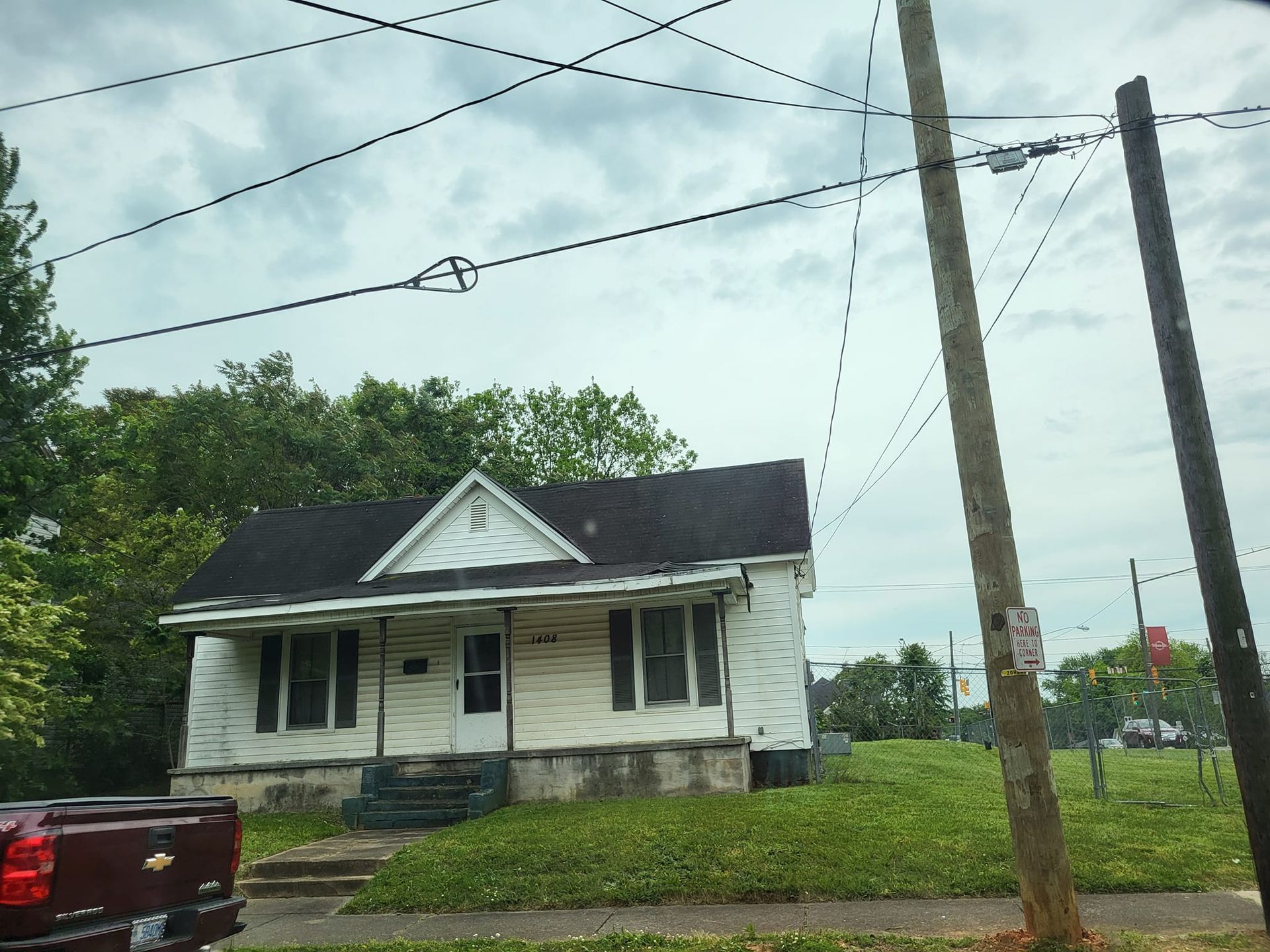 A chevrolet truck is parked in front of a house