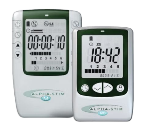 Two white Alpha-Stim medical devices, the M and AID models, shown side-by-side against a white background.