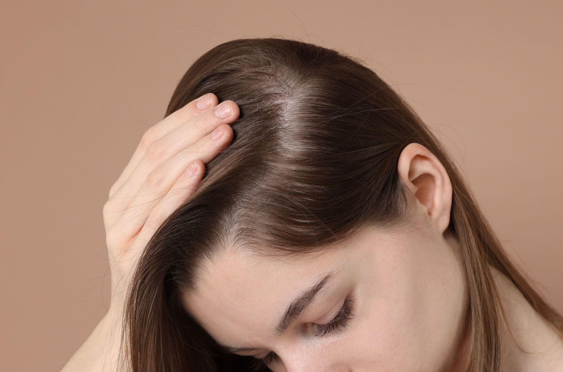 A professional uses a medical device on a person’s forehead in a clinic setting.