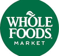 The logo for whole foods market is a green circle with white text.