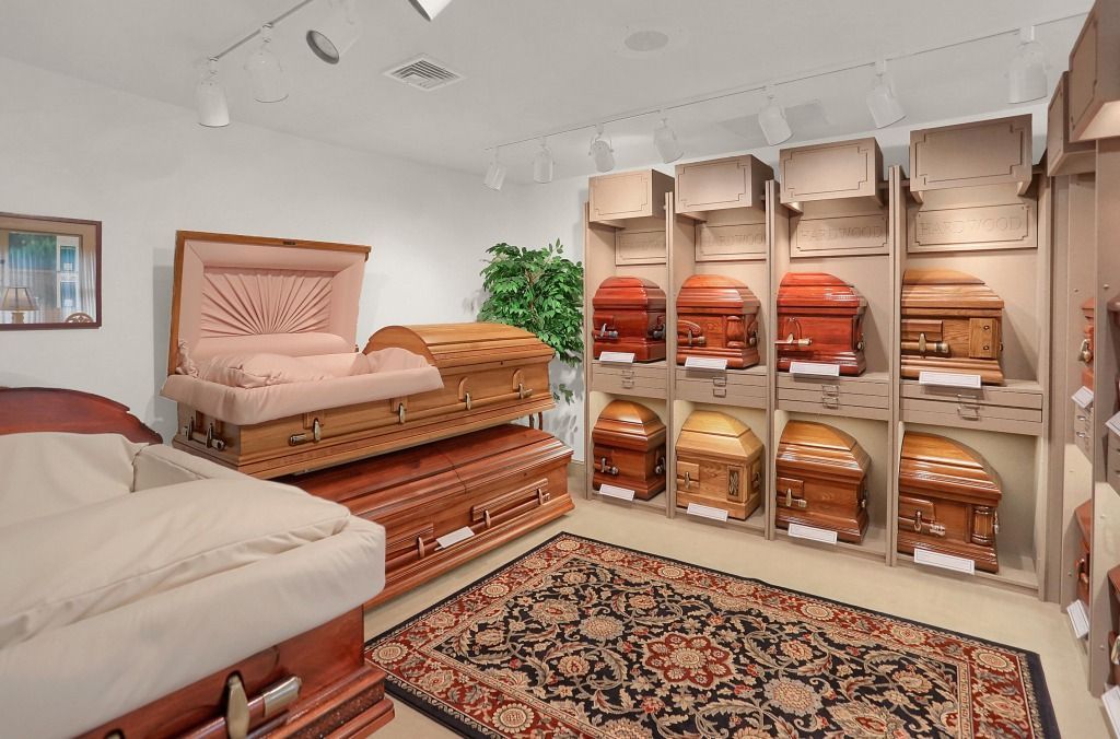 A cozy room with stacked folded blankets, shelves of linens, and patterned rugs under soft lighting