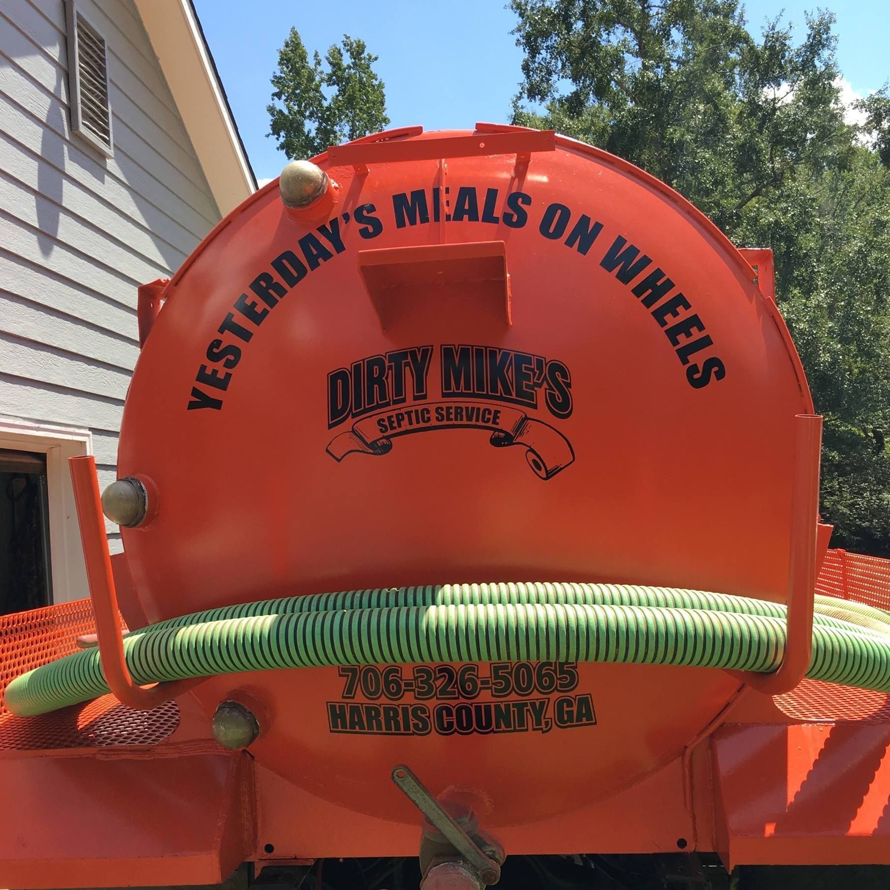 The back of a dirty mike 's vacuum truck