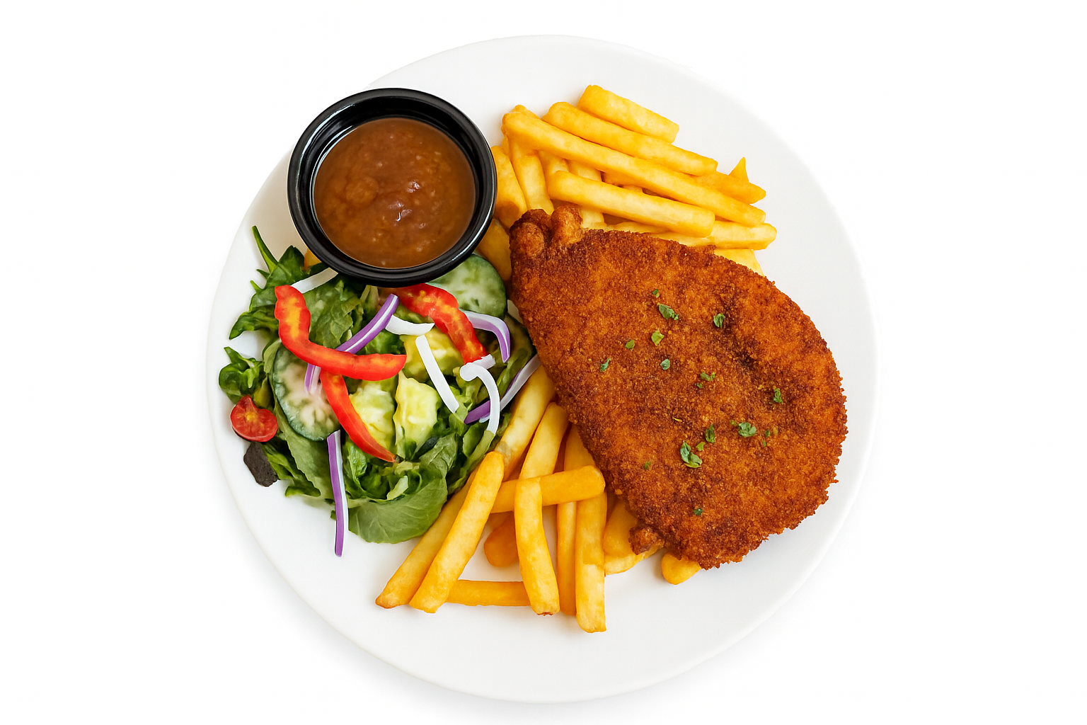 Plate with breaded meat, fries, salad, and sauce in a small black bowl.