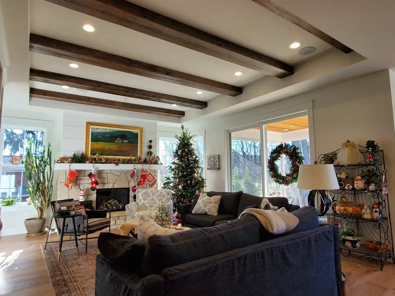Cozy living room with Christmas tree, fireplace garland, and holiday decorations