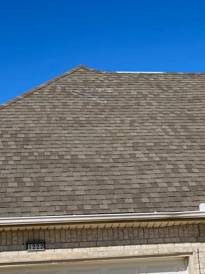 Large shingled roof against a clear blue sky