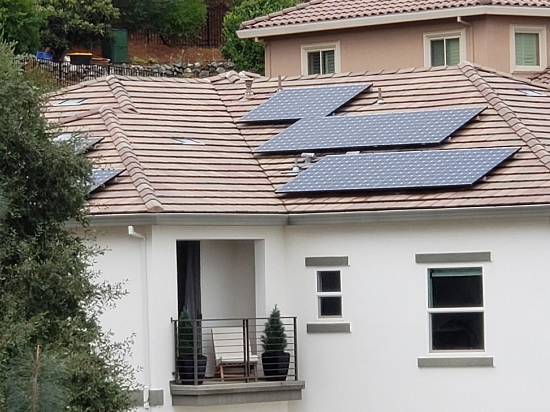White home with 5 solar panels on the roof