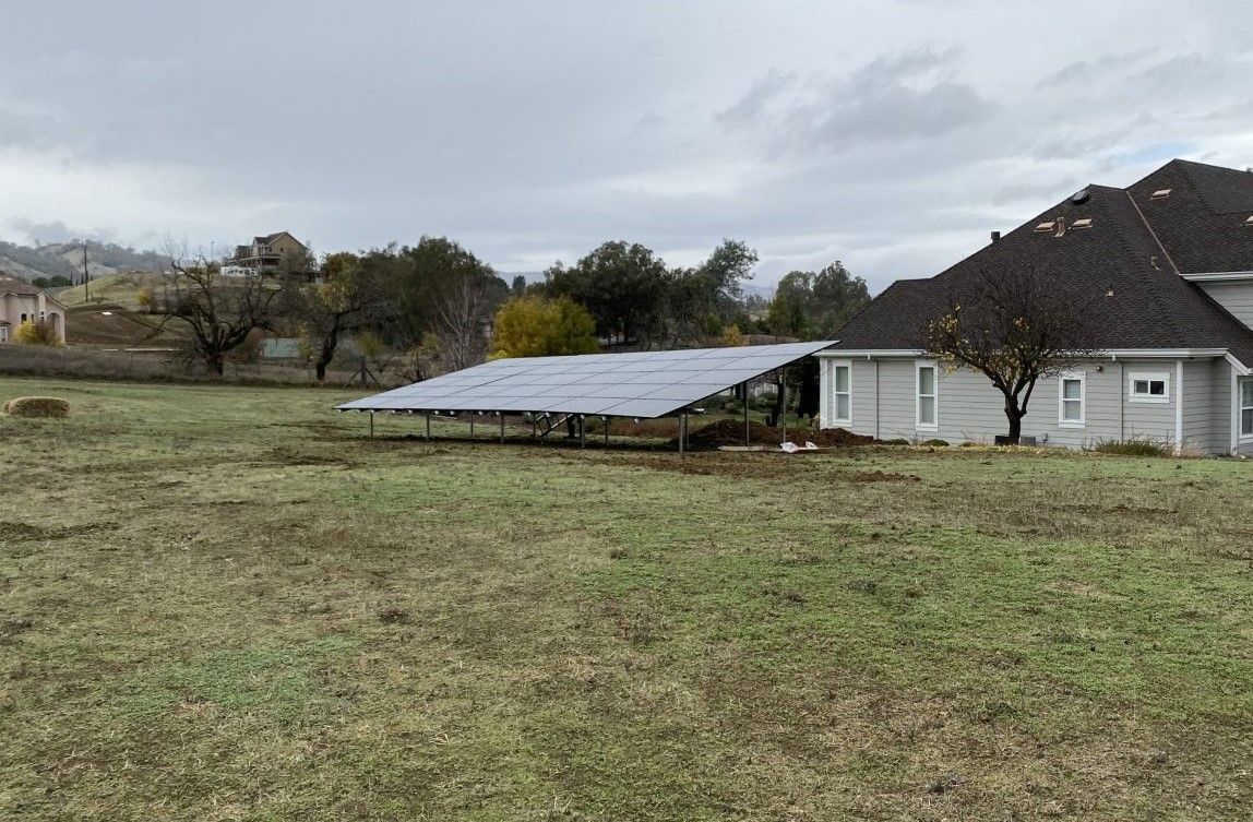 A solar array set on ground level for a rural home