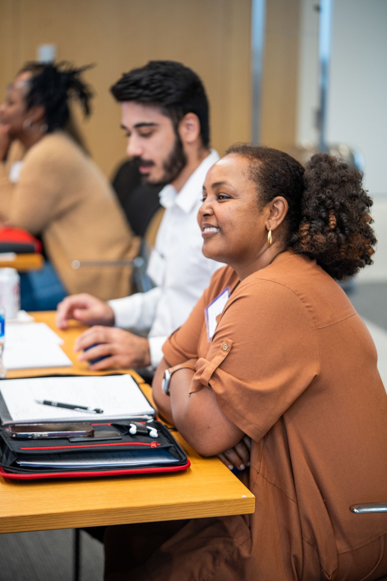 a woman is sitting at a table with a man in a classroom .