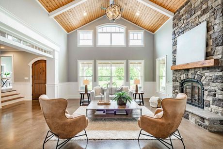 a living room with a vaulted ceiling and a fireplace