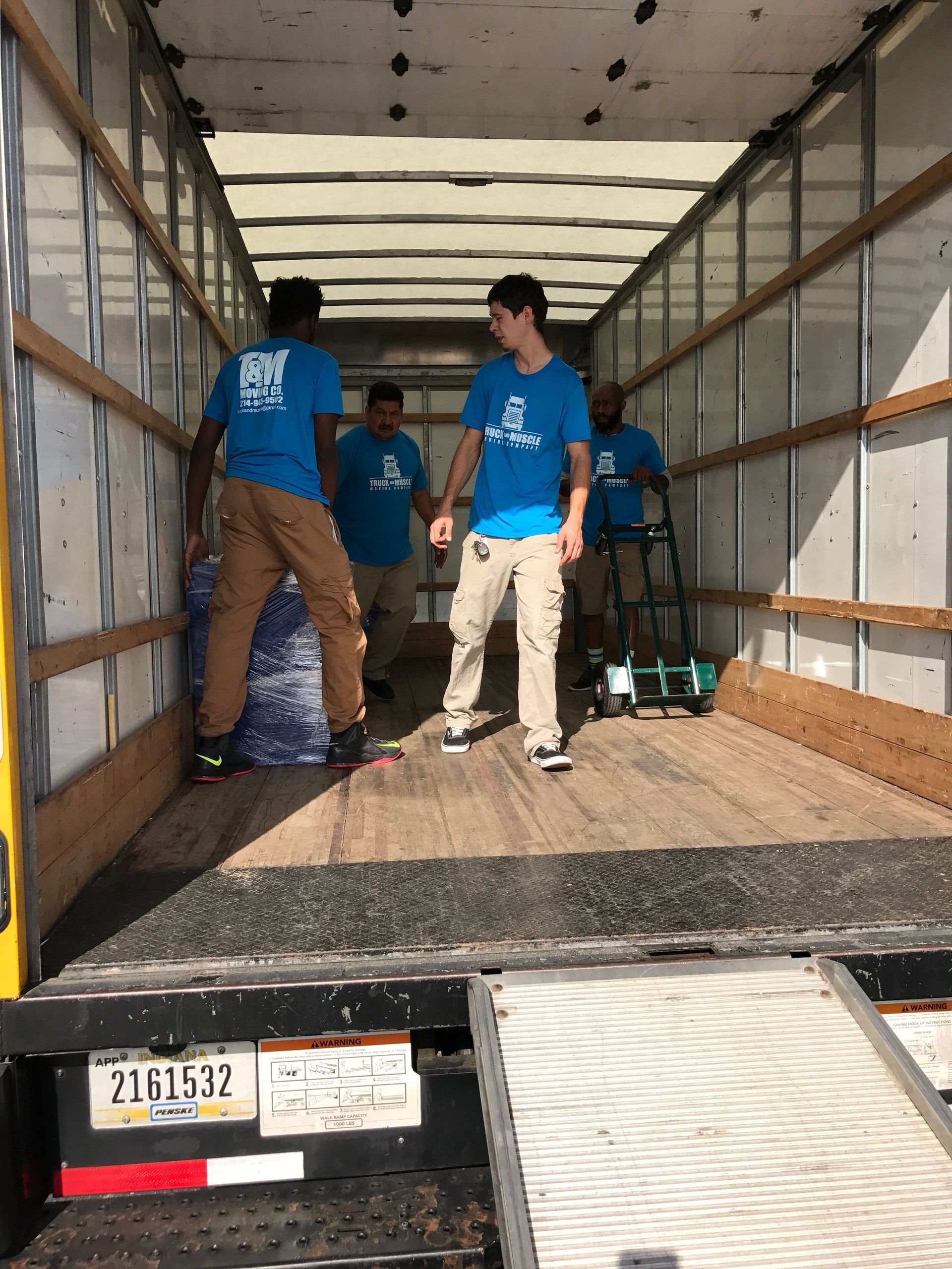 a group of people are standing in the back of a truck